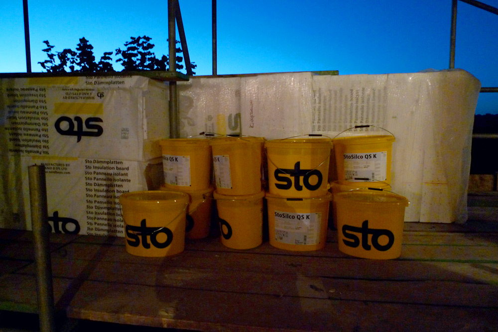 EWI & rainscreen cladding - External wall insulation boards and buckets of pre-mixed silicone resin render